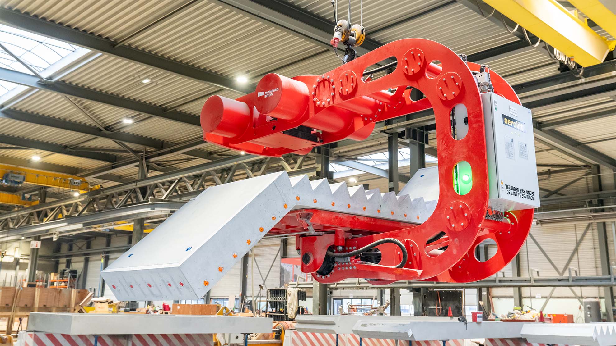 Aerolift 180 degree vacuum tilter handling a precast staircase at Mombarg Beton manufacturing facility